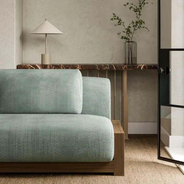 blue striped sofa with side table and vases