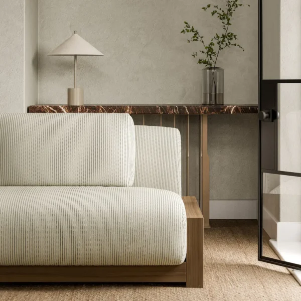 white striped sofa with side table and vases