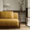 orange striped sofa with side table and vases