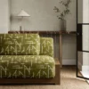 green geometric sofa with side table and vases