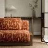 red geometric sofa with side table and vases