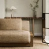 brown plain sofa with side table and vases