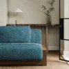 blue plain sofa with side table and vases