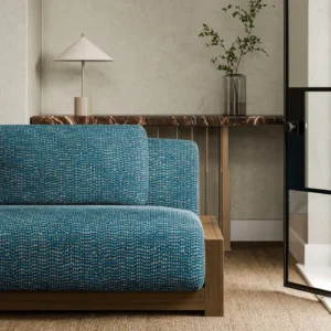 blue plain sofa with side table and vases