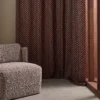 red misc curtain with armchair and window
