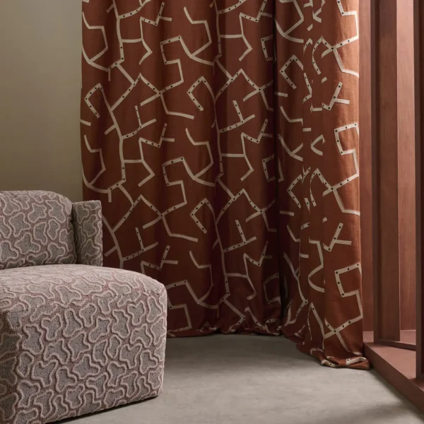Saraceno Fabric - Rust by red misc curtain with armchair and window