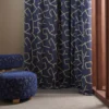 blue misc curtain with armchair and window