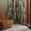 green geometric curtain with armchair and window