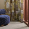 multicolour geometric curtain with armchair and window