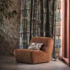 red geometric curtain with armchair and wall