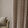 red spotted curtain with wall and cushion