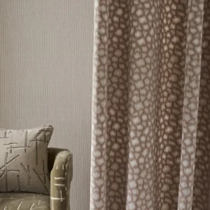 red spotted curtain with wall and cushion