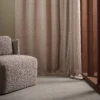 red spotted curtain with armchair and window