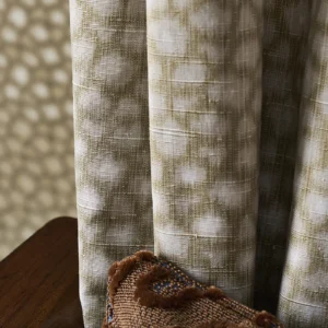 green spotted curtain with wall and cushion