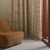 brown striped curtain with armchair and window