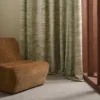 green striped curtain with armchair and window