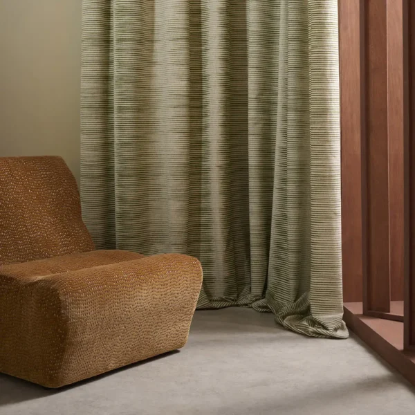Chaco Fabric - Moss by green striped curtain with armchair and window