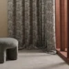 blue geometric curtain with armchair and window