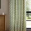 green botanical curtain with cabinets and window