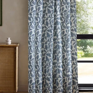 blue botanical curtain with cabinets and window