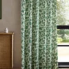 green botanical curtain with cabinets and window
