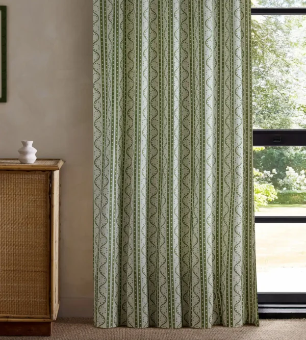 green striped curtain with cabinets and window
