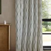 green geometric curtain with cabinets and window