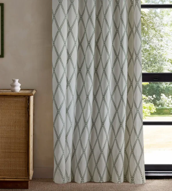 green geometric curtain with cabinets and window