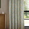 yellow botanical curtain with cabinets and window