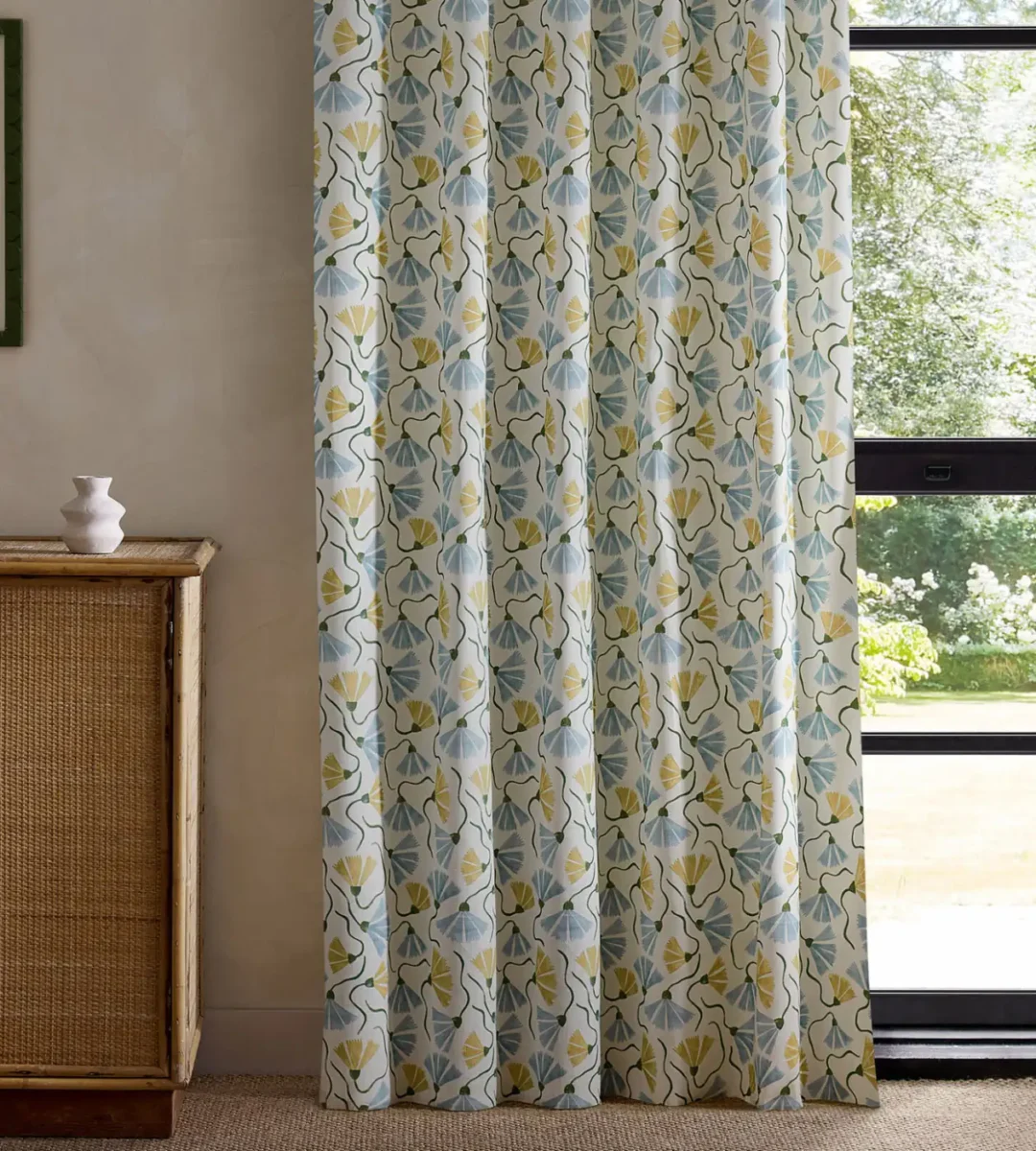 yellow botanical curtain with cabinets and window