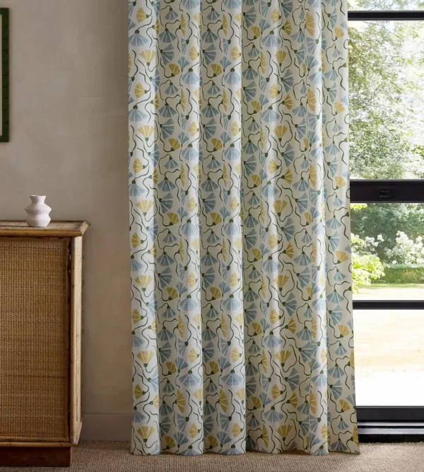 yellow botanical curtain with cabinets and window