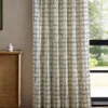 green checked curtain with cabinets and window