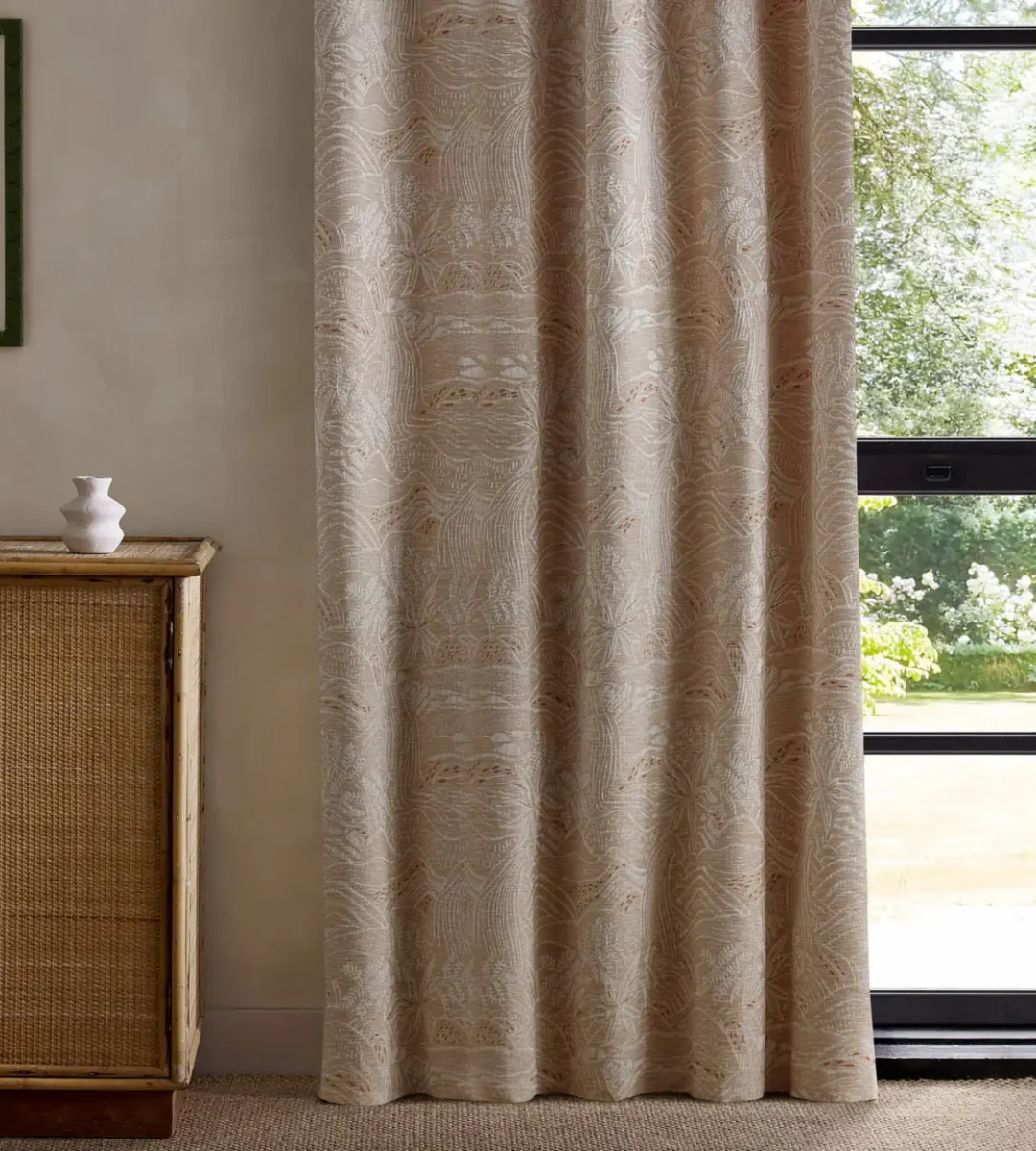 orange botanical curtain with cabinets and window