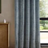 blue botanical curtain with cabinets and window