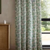 green botanical curtain with cabinets and window