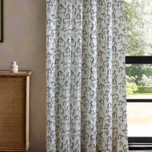 blue animal curtain with cabinets and window