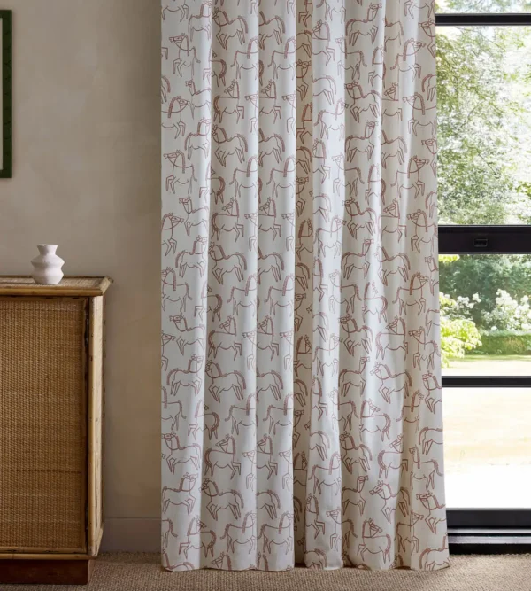 pink animal curtain with cabinets and window