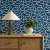 blue misc wallpaper and wall with cabinets and vases