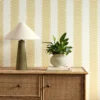 yellow striped wallpaper and wall with cabinets and vases