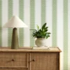 green striped wallpaper and wall with cabinets and vases