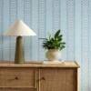 blue striped wallpaper and wall with cabinets and vases