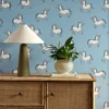 blue animal wallpaper and wall with cabinets and vases