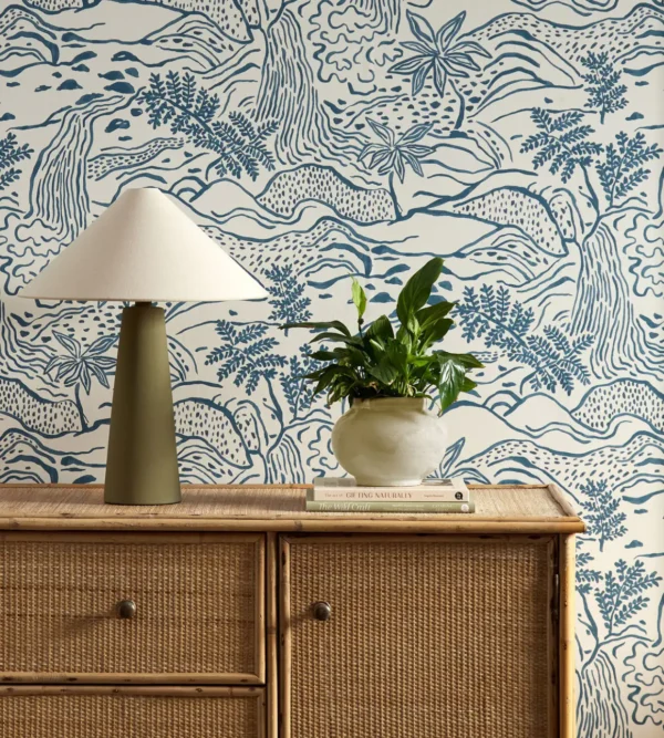 blue botanical wallpaper and wall with cabinets and vases