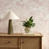 pink botanical wallpaper and wall with cabinets and vases