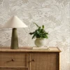 neutral botanical wallpaper and wall with cabinets and vases