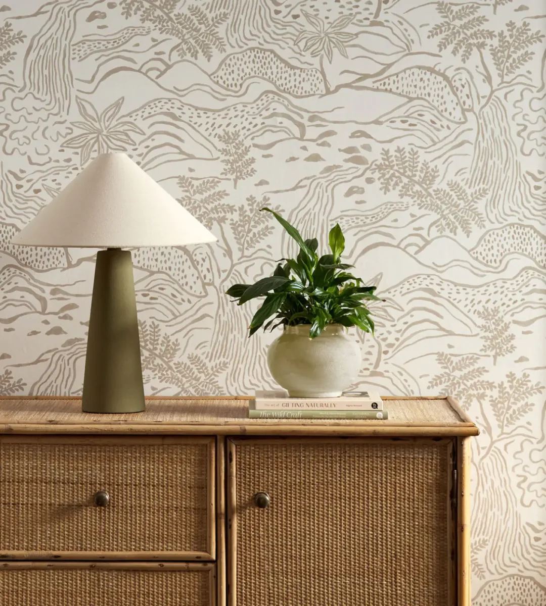 neutral botanical wallpaper and wall with cabinets and vases