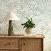 green botanical wallpaper and wall with cabinets and vases