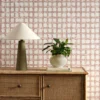 red checked wallpaper and wall with cabinets and vases