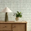 green checked wallpaper and wall with cabinets and vases
