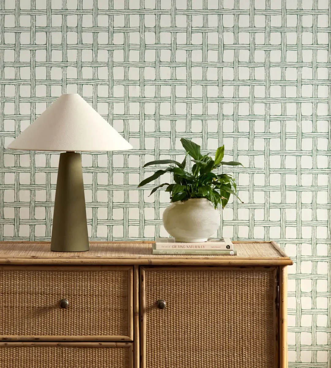 green checked wallpaper and wall with cabinets and vases